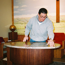 Mike ajdusts the positioning of the new altar top.