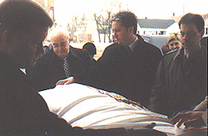 The funeral pall is placed on the casket.