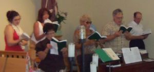 The choir sings the opening hymn with the people.