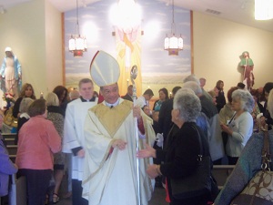 As he leaves, Bishop Perry greets individuals.
