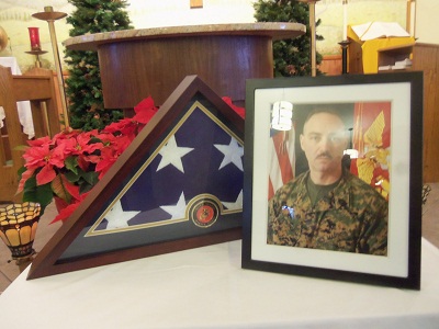 At the Memorial Mass for Master Gunnery Sargeant Jim Petrongelli, his flag and photo were placed in front of the altar, on a table.