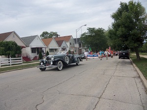 An antique car leads the procession.