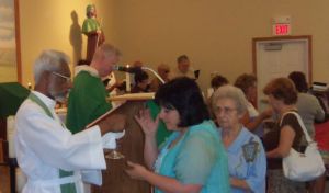 Father Jacob helps with Communion.